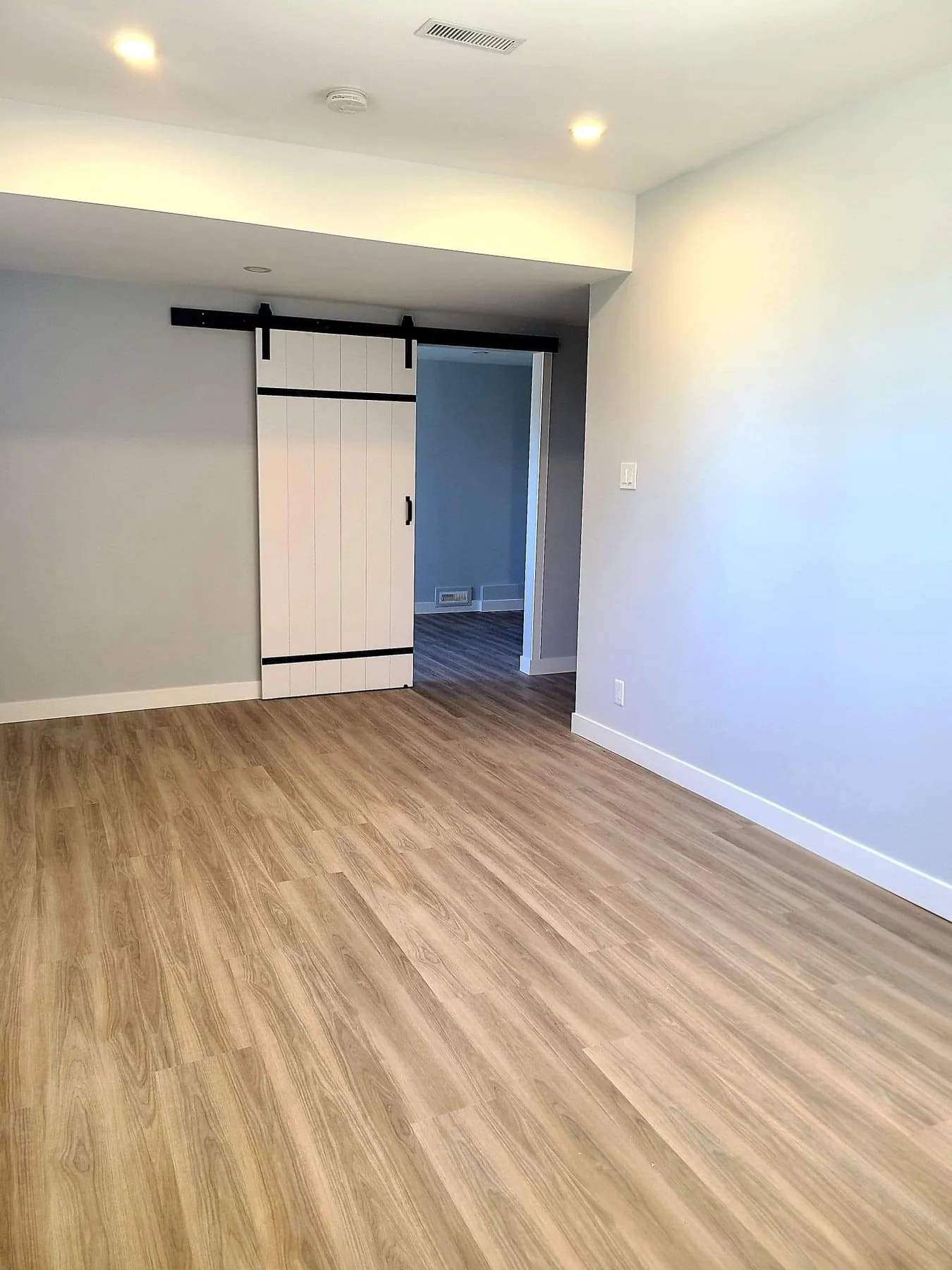 Finished hallway with barn door and new flooring